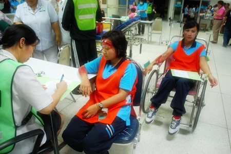 Actresses play their roles as injured tourists during the training exercises.